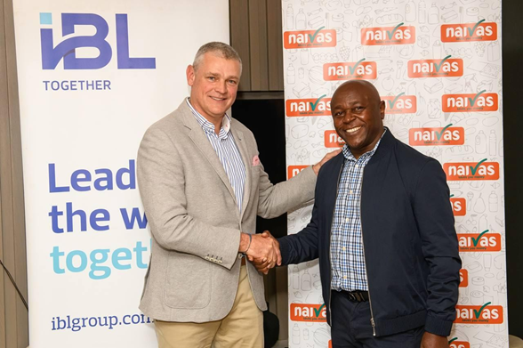 Handshake between Arnaud Lagesse, IBL Group CEO and David Kimani, Naivas Managing Director