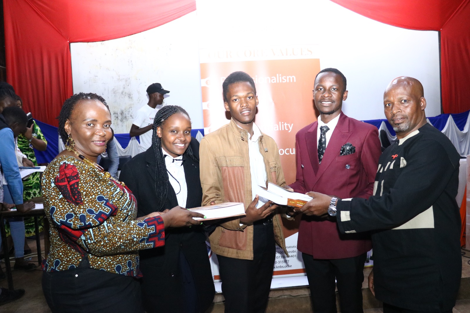 KNBS Snr Manager,NAS Benjamin Muchiri (right) and KNBS HR Manager and Dir Rose Awino(left) present Statistics learning books to TUK after giving a keynote speeches on career talk ,health and HIV/AIDS Awareness in Nairobi on 1st Dec 2023