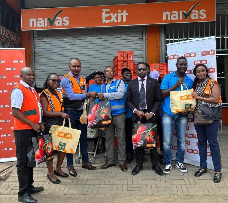 Naivas Supermarket Management team and customers posing for a photo
